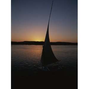  Sunset Outlines the Curve of a Felucca Sail on the Nile 