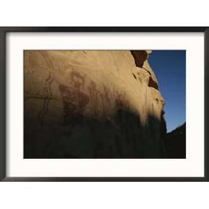  Indian pictographs cover a sandstone wall Scenic Framed 