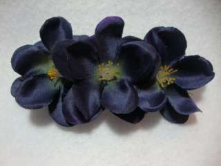 Three quality navy blue flowers are lined up on a french barrette 